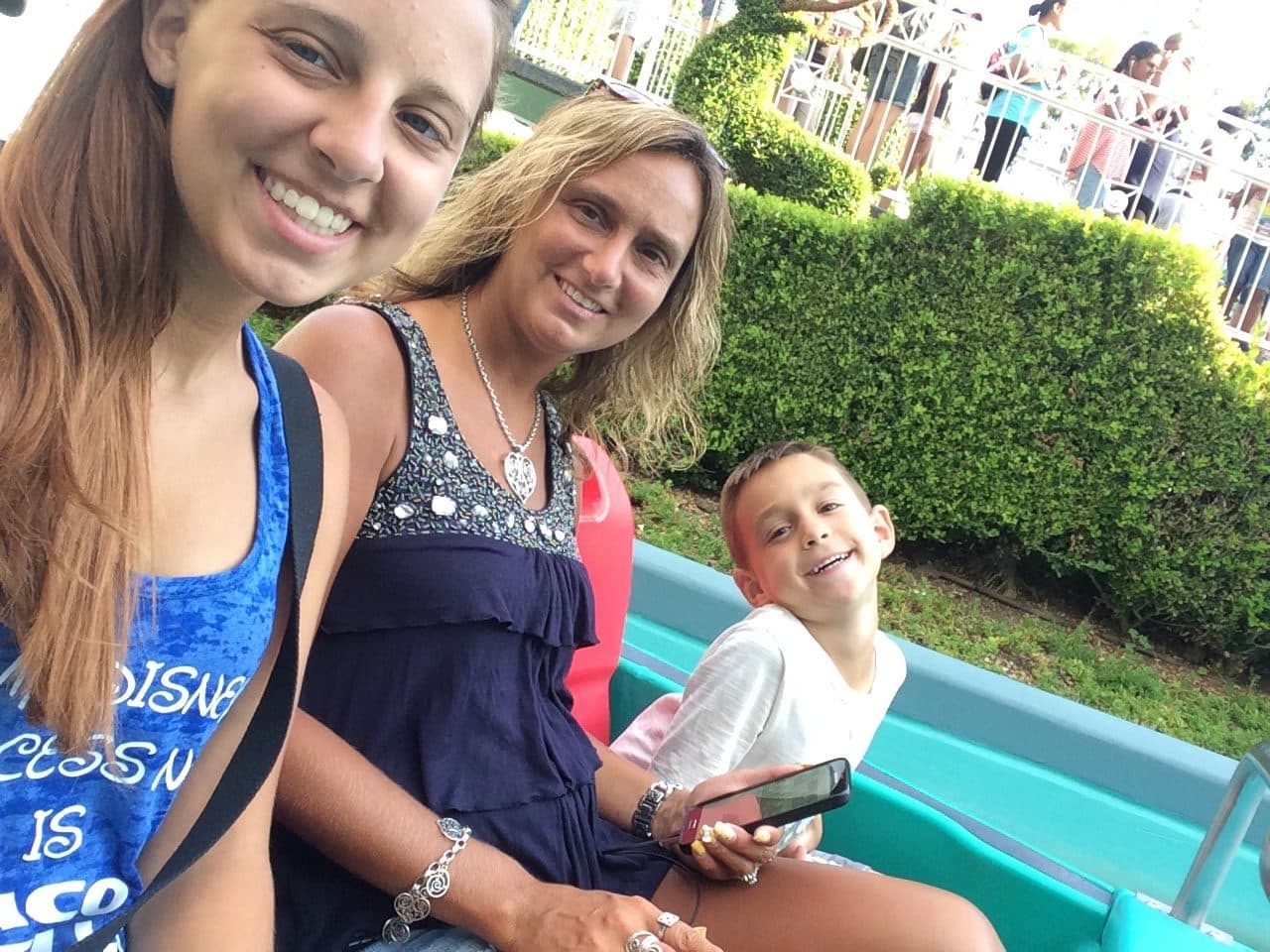 Three generations riding the Mad Tea Party teacups